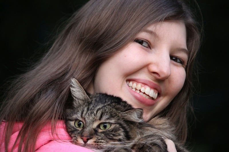 Holding a cat in your arms